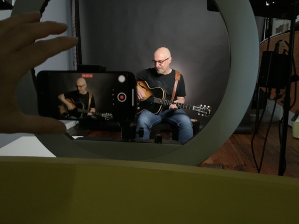 Jim Playing guitar in photo studio