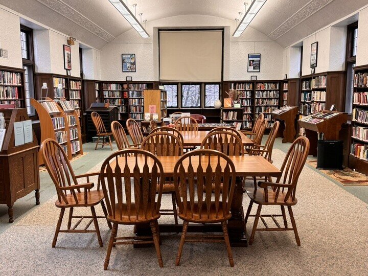Waban Library reading room with bookshelves chairs and tables
