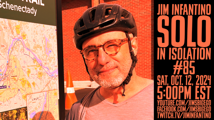 Jim wearing bicycle helmet next to a map of upstate new york