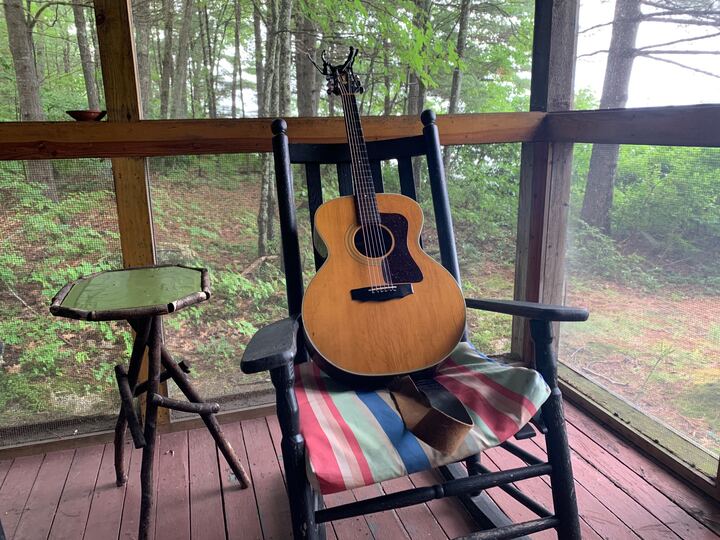 Jims Guitar on Porch in Woods